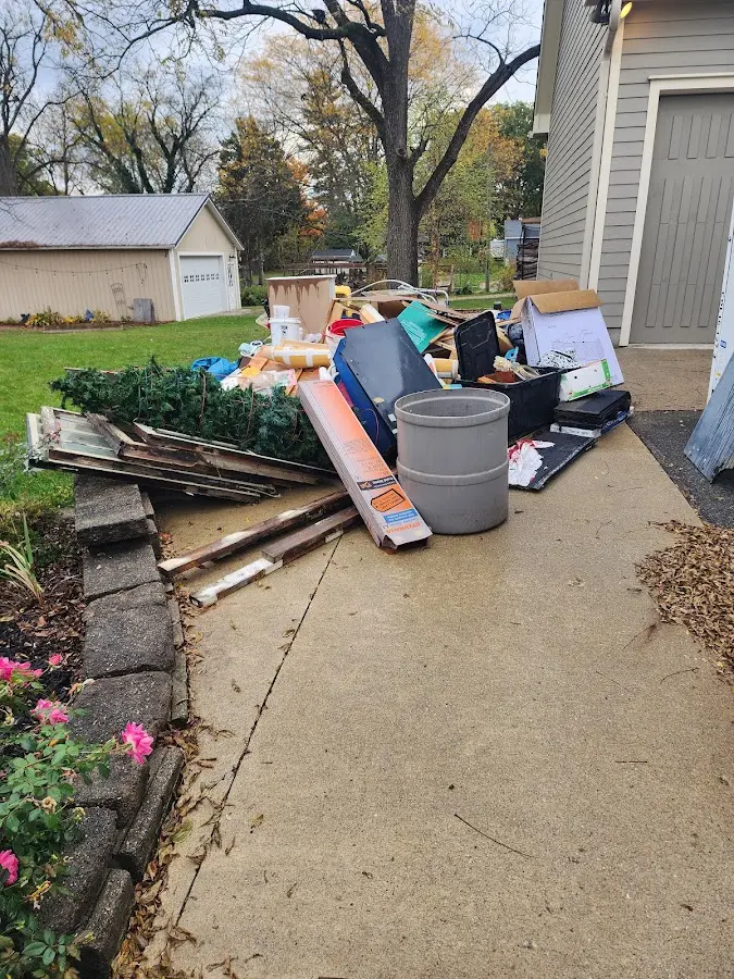 Dumpster being loaded with debris for 3 Yard Dumpster Rental in Akron